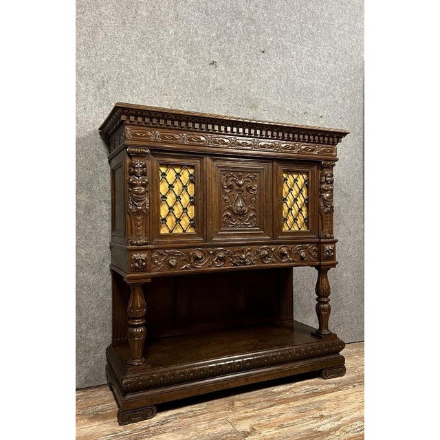 Renaissance-style walnut and oak cabinet circa 1850 it features two wrought-iron openwork doors and a 360° pivoting carved...