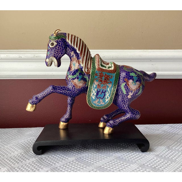 A vibrant and finely detailed vintage Chinese cloisonné horse figurine, posed mid-stride with one front leg raised in a...