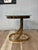 A striking Postmodern side table executed in polished brass with a thick circular glass top. The sculptural pedestal base...