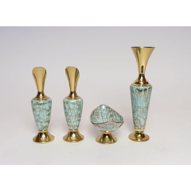 Collection of four hand-painted Delftware vessels - one boat shape decorative bowl/vide poche, two ewers, and one vase...