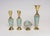 Collection of four hand-painted Delftware vessels - one boat shape decorative bowl/vide poche, two ewers, and one vase...