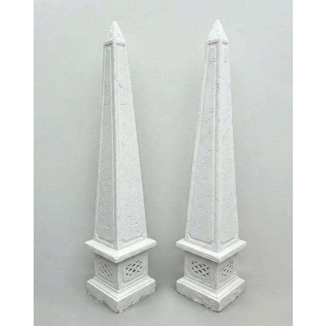 Elevate your outdoor landscape with this striking pair of grand-scale obelisks, crafted from durable cast stone with a...