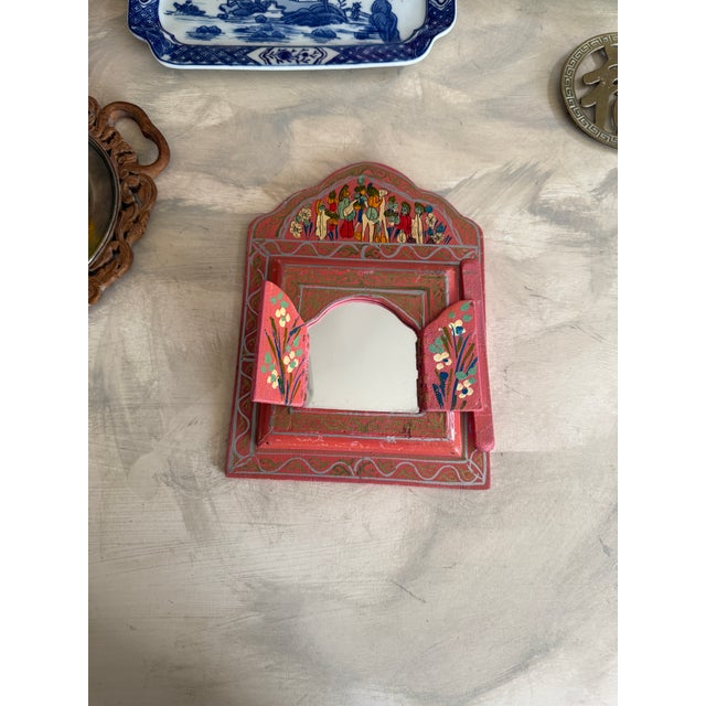 Vibrant vintage folk art painted mirror crafted from wood and decorated by hand in richly layered colors. The arched,...