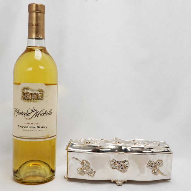 A highly decorative and shiny Art Nouveau silver plated vanity box that is festooned on the front and lid with bas-relief...