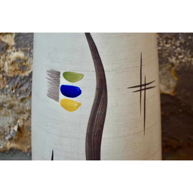 Vintage West German production, this cylindrical vase is typical of midcentury productions. The decor consists of...