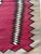 This exceptional 1920s Navajo rug features a bold red field framed by dramatic serrated (zigzag) borders and anchored by a...