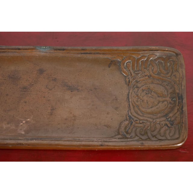 An authentic Tiffany Studios antique bronze pen or pencil desk tray in the iconic Zodiac design. Clearly signed by Tiffany...