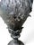 Elegant antique French cast-metal urn, approximately 9 inches tall, featuring an exceptional Neoclassical design with Art...