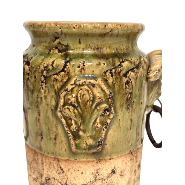 Vintage Half-Glazed Ceramic Vase by Hosley Pottery featuring a green finish, fleur-de-lis emblems, and iron loop handles....