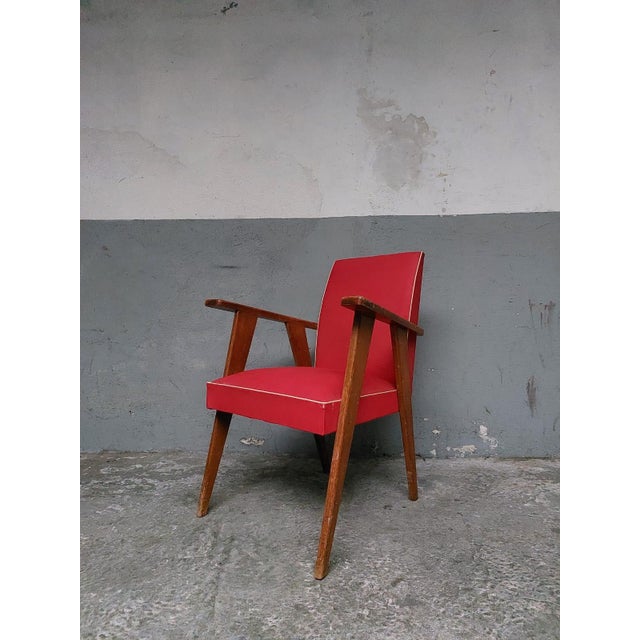 The chair has signs of wear: two holes in the upholstery at the front. The wood could use a new varnish.