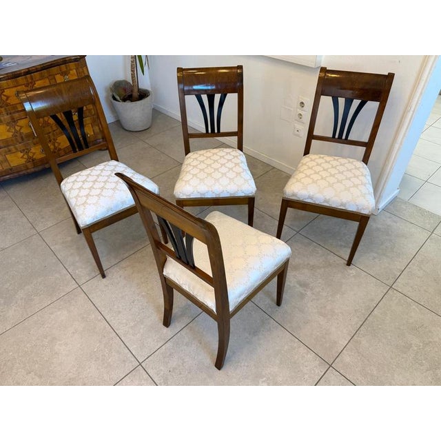 Set of 4 restored Biedermeier walnut armchairs. Dimensions: Height x Width x Depth 90 x 47 x 43 cm x Seat height 46 cm....