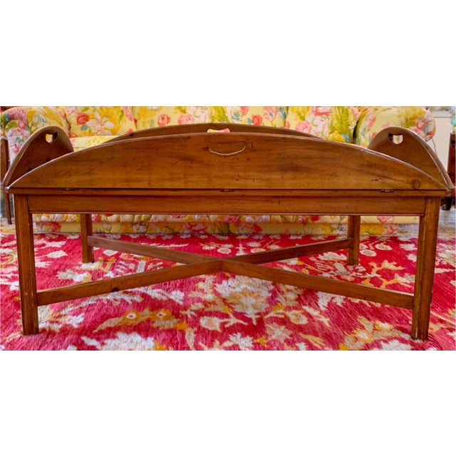 A late 20th century Georgian style Yew wood butler's tray-top coffee table with an open-handled tray with fold down sides...
