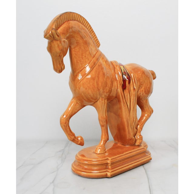 Mid-century ceramic Tang-style Trojan horse figurine. Features a glossy mustard-yellow glaze and a classic draped red...