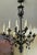 Large-scale mid-20th century hand-forged wrought iron chandelier featuring a twisted central stem with scrolling arms and...