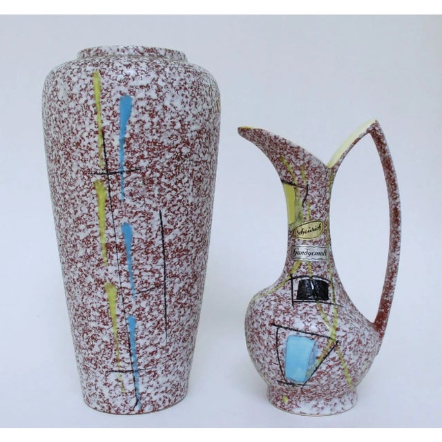 Two mid-century Scheurich ceramic vases in matching mottled glazes with hand-painted atomic age-style decoration. Both...