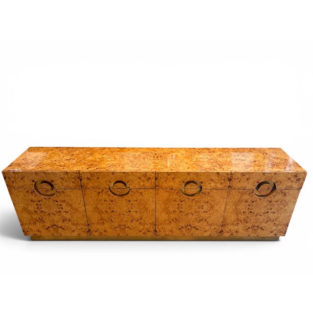 An elegant Italian sideboard crafted from natural burl veneer with brass details, produced in the 1970s. It stands out for...
