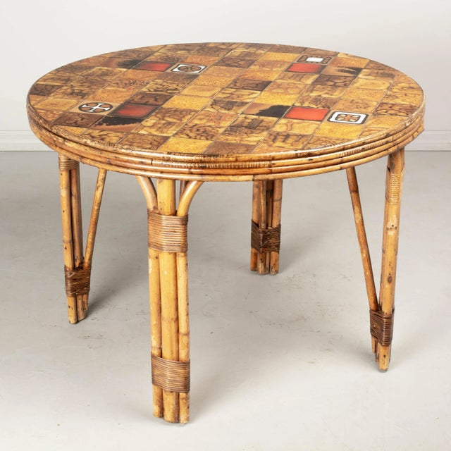 A vintage French Vallauris pottery tile top table with sturdy rattan base. Each glazed ceramic tile is unique and laid out...