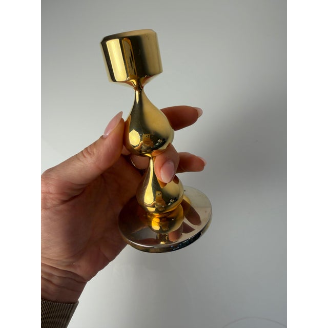 A luxurious highlight of Danish 70s design: This 24-karat gold-plated candlestick by Hugo Asmussen for Asmussen Design...