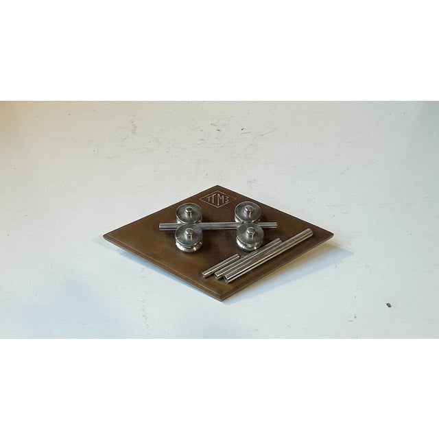 A stylized desk/horizontal plaque or sculpture fashioned from stainless steel and bronze. Distinct industrial/machine age...