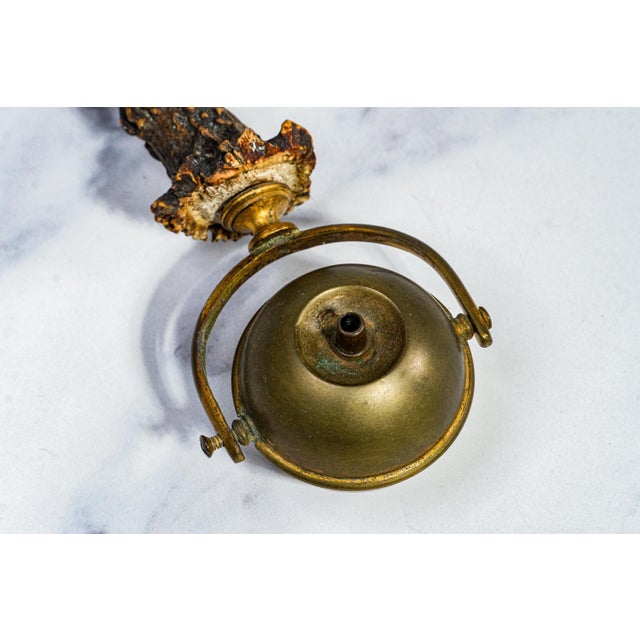 This striking circa 1900 antler-handle brass gimbal cigar lighter is a superb example of early tobacciana, blending...