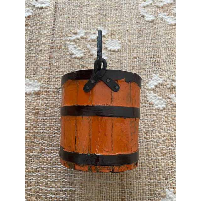 The Antique Primitive Wooden Forged Iron Rice Berry Bucket in orange is a unique and charming piece that combines...
