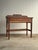 This antique console table features a shaped gallery back with carved detailing that gives the piece a refined yet...