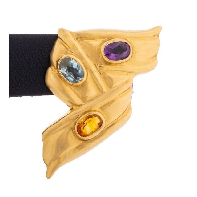 These stunning 14k yellow gold earrings showcase a unique, sculptural design, reminiscent of a stylized ribbon or abstract...