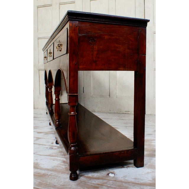 A Superb Georgian Oak Dresser Base. Made from English Oak, with three drawers retaining the original brass handles, a...