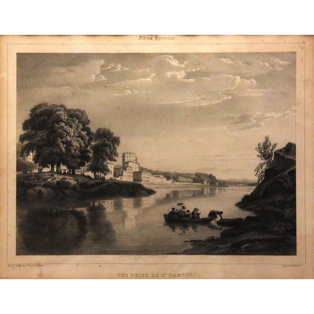 This lithograph, sized 24" x 21", features a scene of a river with several boats navigating its waters. The central...