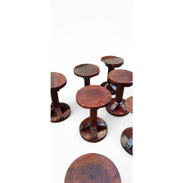 Wooden stools with large, decorative studs, dating back to the 1970s, made in Italy. The seat tops differ on the...
