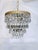 This is an Italian brass rim chandelier dressed with octagon bead and Swedish cut crystals. It has 1 Edison base socket...