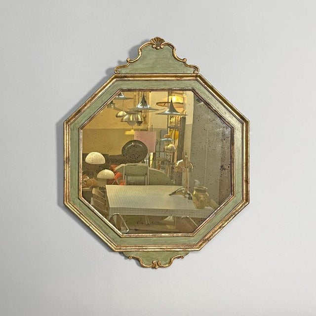 Italian antique octagonal wall mirror in green wood with golden profiles, 1700s Octagonal wooden wall mirror. The...