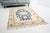 This is a vintage Turkish Oushak rug from the Mid 20th Century. The piece was hand-knotted.