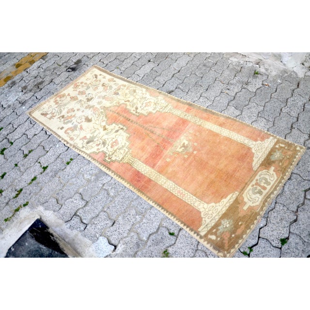 This is a vintage Turkish Oushak rug from the 1960s. The piece was hand-knotted.
