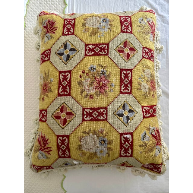Stylish needlepoint pillow with decorative trim. Geometric/floral motif in a pseudo-Victorian style. Primary colors are...