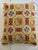 Stylish needlepoint pillow with decorative trim. Geometric/floral motif in a pseudo-Victorian style. Primary colors are...