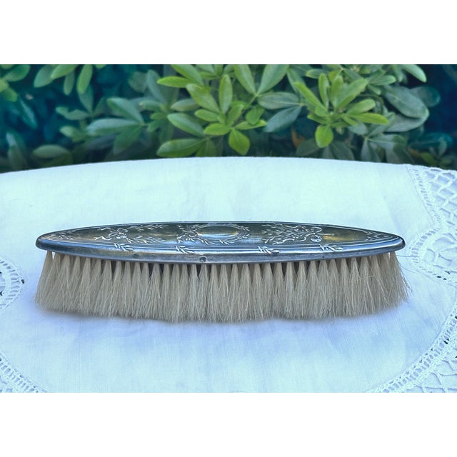 A lovely antique dress brush decorated with crossed ribbons and laurel leaves in the Louis XVI style Central medallion...