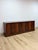 This mahogany credenza by Aurora showcases a refined transitional silhouette, finished in a rich, warm mahogany tone with...