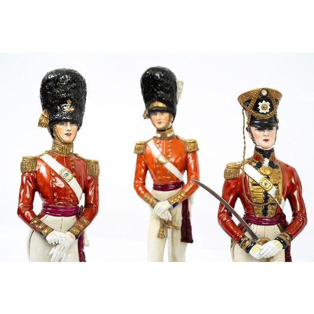 A set of five antique soldiers in polychrome Capodimonte porcelain, depicting British soldiers from the 20th century....