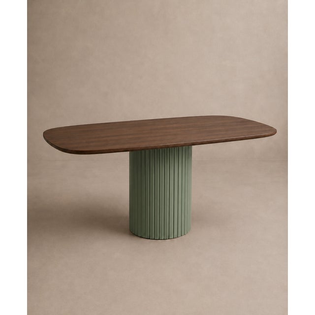 A sculptural table, where the warmth of dark walnut meets the delicate hues of sage green. The contoured top is...