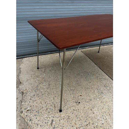 Ray and Charles Eames for Herman Miller Folding Rectangular Dining Table. Walnut refinished. Legs show typical wear and...