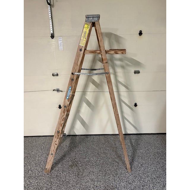 Elevate your rustic farmhouse or industrial loft decor with this authentic vintage 6-foot Werner wooden step ladder....
