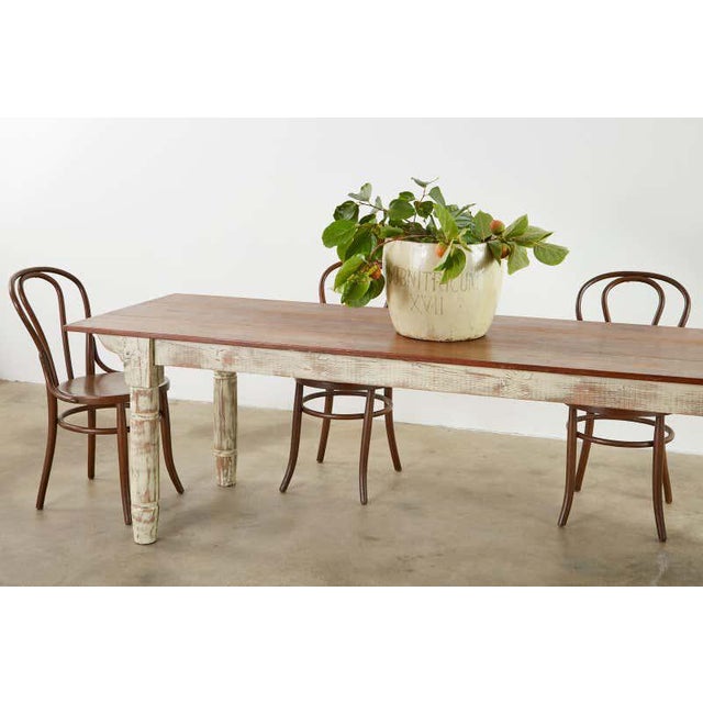 Rustic American country pine farmhouse dining table. Featuring a three wood plank top with bread board ends supported by a...