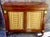 Elegant vintage credenza by Kittinger, crafted in richly figured mahogany with beautifully detailed brass grille doors and...