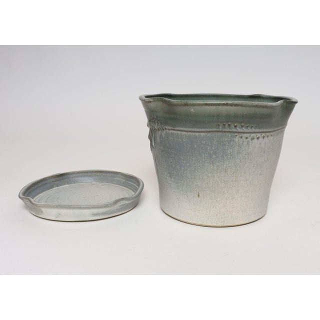 Studio ceramic planter with drainage hole and plate/saucer by ceramicist, Deanna Nichols (b. 1942-2017, Missouri). Holding...