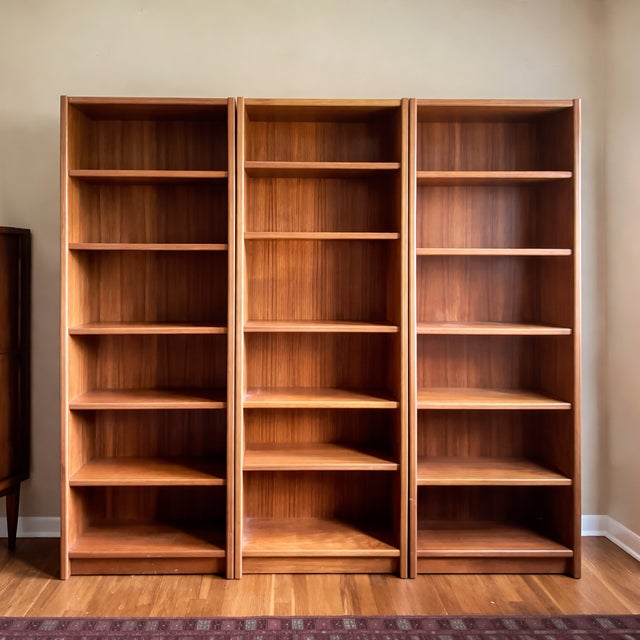 1970s Danish teak bookcase units. Teak veneer case construction Adjustable shelving throughout Clean rectangular form with...