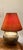 This captivating large lamp’s focal point is the deeply carved or molded relief figures with distinct faces and geometric...