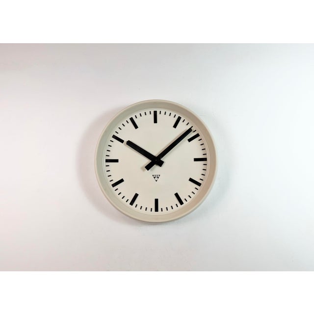 This large wall clock was produced by Pragotron in former Czechoslovakia during the 1960s. It features a beige bakelite...