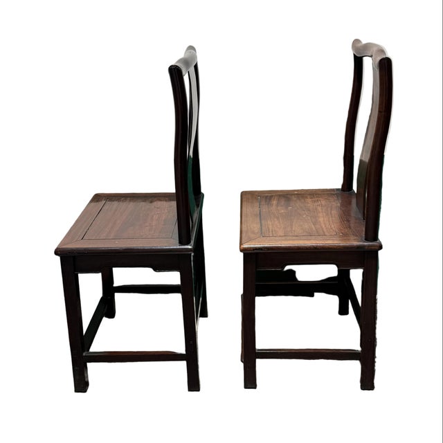 Fantastic pair of wooden Chinese dining chairs. Hand constructed in a Ming style design with a very angular build. Foot...