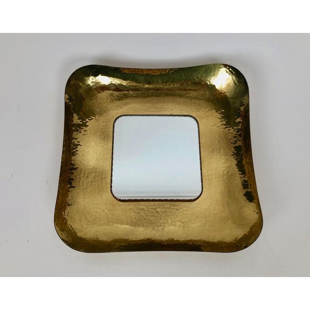 An exquisite hand hammered mid-century brass mirror made by Austrian craftsmen, in the 1950's. The excellent hand work...
